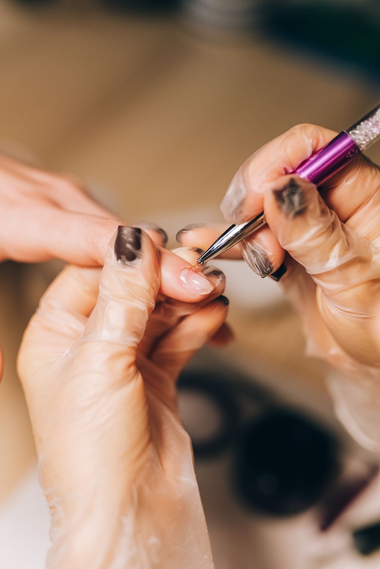 Nail stylist gently caring for the cuticles during a manicure
