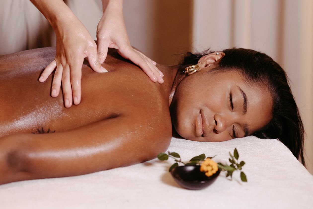 Woman lying down with her eyes closed, relaxing during a gentle massage